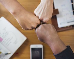 Diverse people giving a fist bump